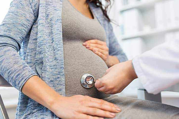 Gynaecologist discussing a check-up with a woman patient in a clinic